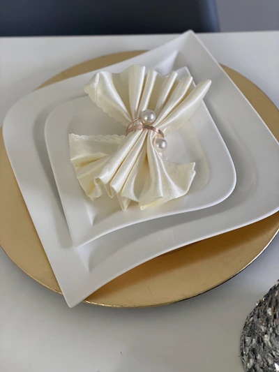 Elegant round plates with subtle textures arranged on a linen tablecloth.