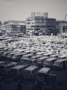 A busy wholesale vehicle showroom with various trucks and vans.