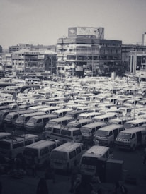 Delivery vans lined up outside a busy local business district.