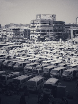 A busy wholesale vehicle showroom with various trucks and vans.