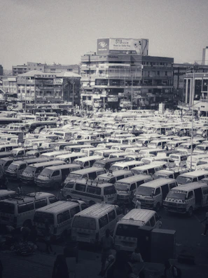 A fleet of Rapid Reverse vans lined up, ready for pickups in a busy city.