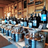 Bottles of herbal syrups neatly arranged on a wooden shelf.