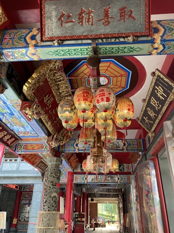 A vibrant Chinese restaurant interior with red and gold decorations and traditional Chinese calligraphy on the walls.