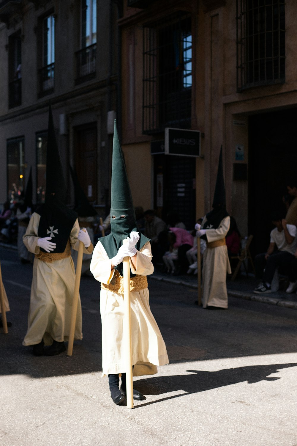 a man in a green hat holding a green pole