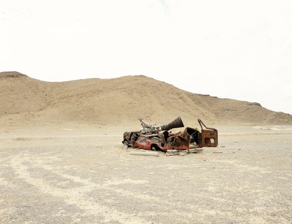 a rocket engine and a crashed car in a desert 