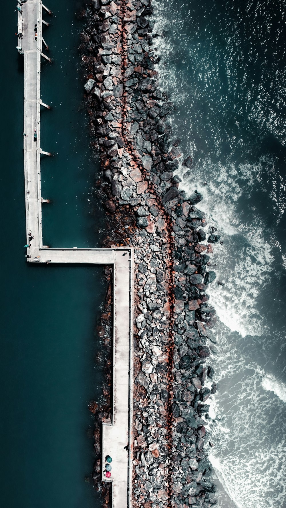 an aerial view of a pier and the ocean