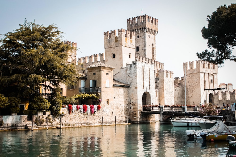 a castle like building next to a body of water