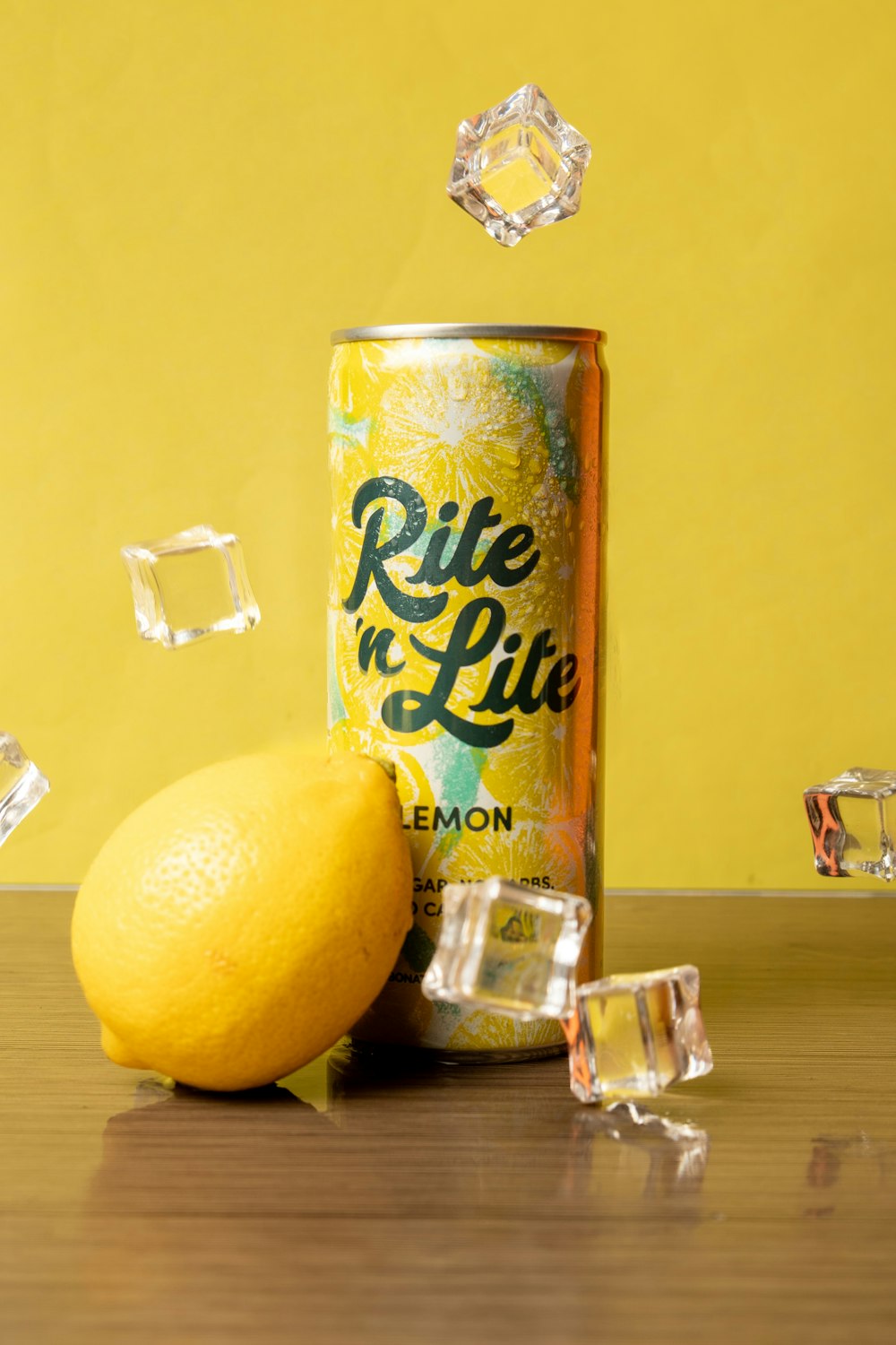a can of lemonade and ice cubes on a table