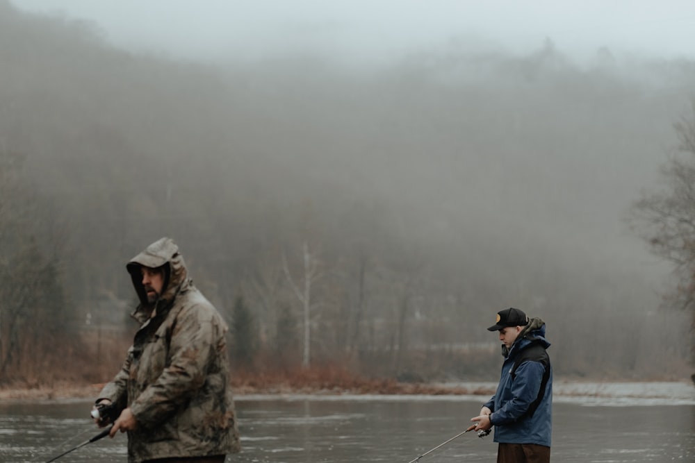 a man and a woman fishing in a river