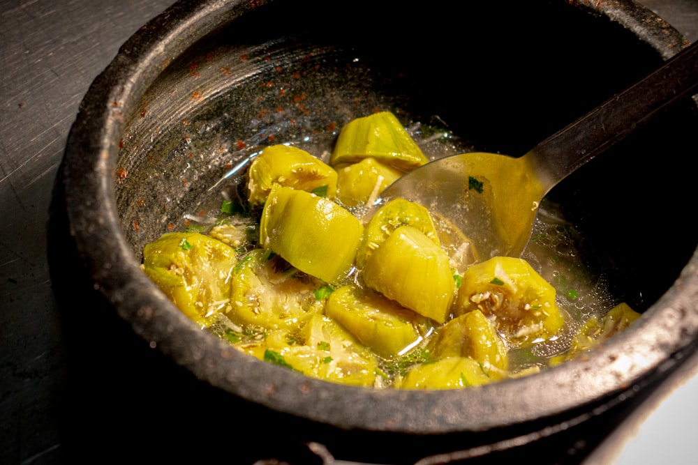 a pot filled with food sitting on top of a stove