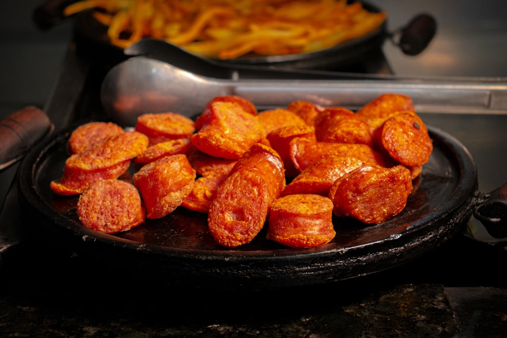 a plate full of hot dogs on a counter