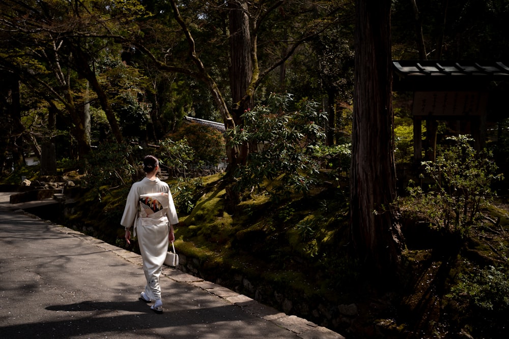 a person walking down a path in the woods