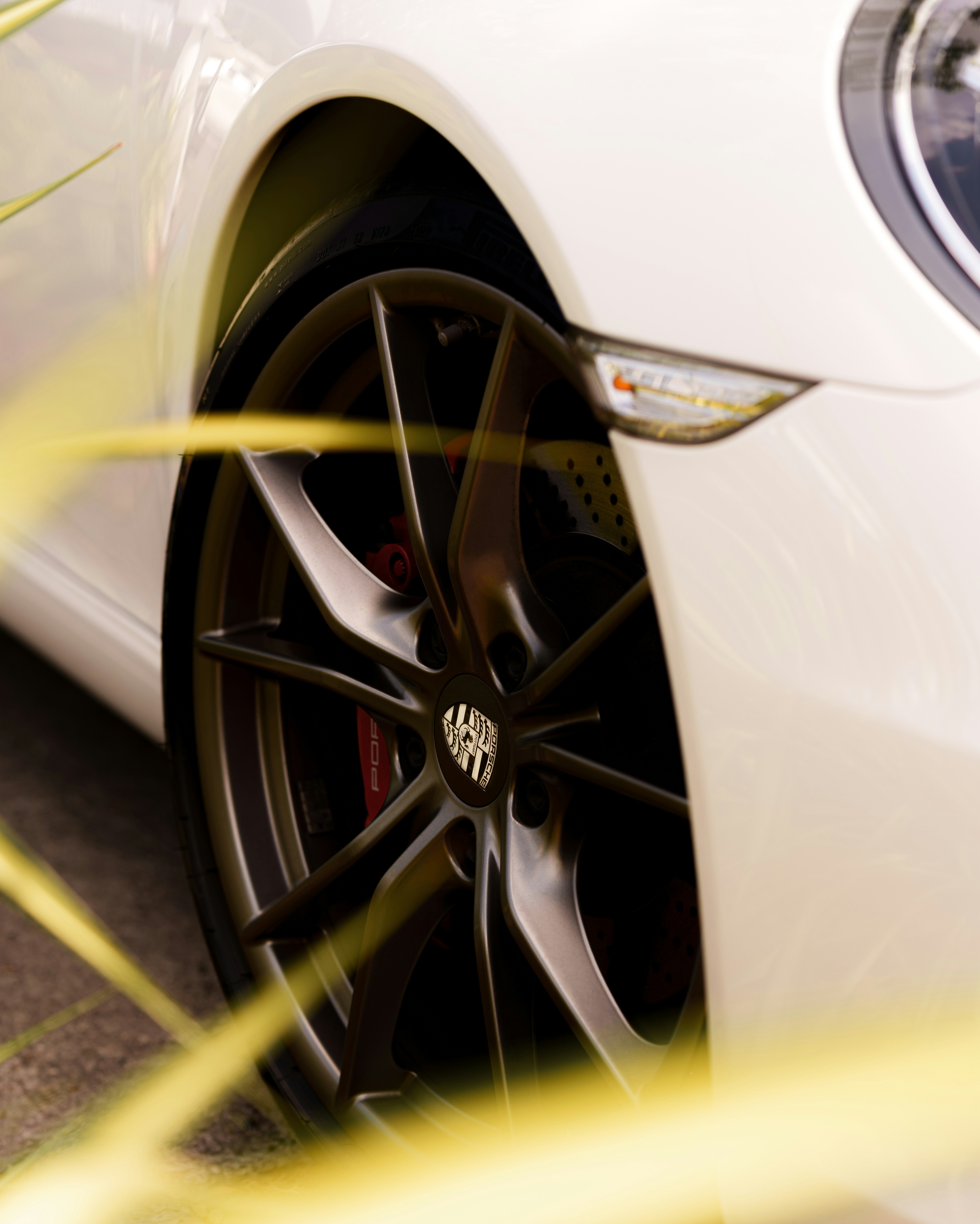 a close up of a white car parked on a street