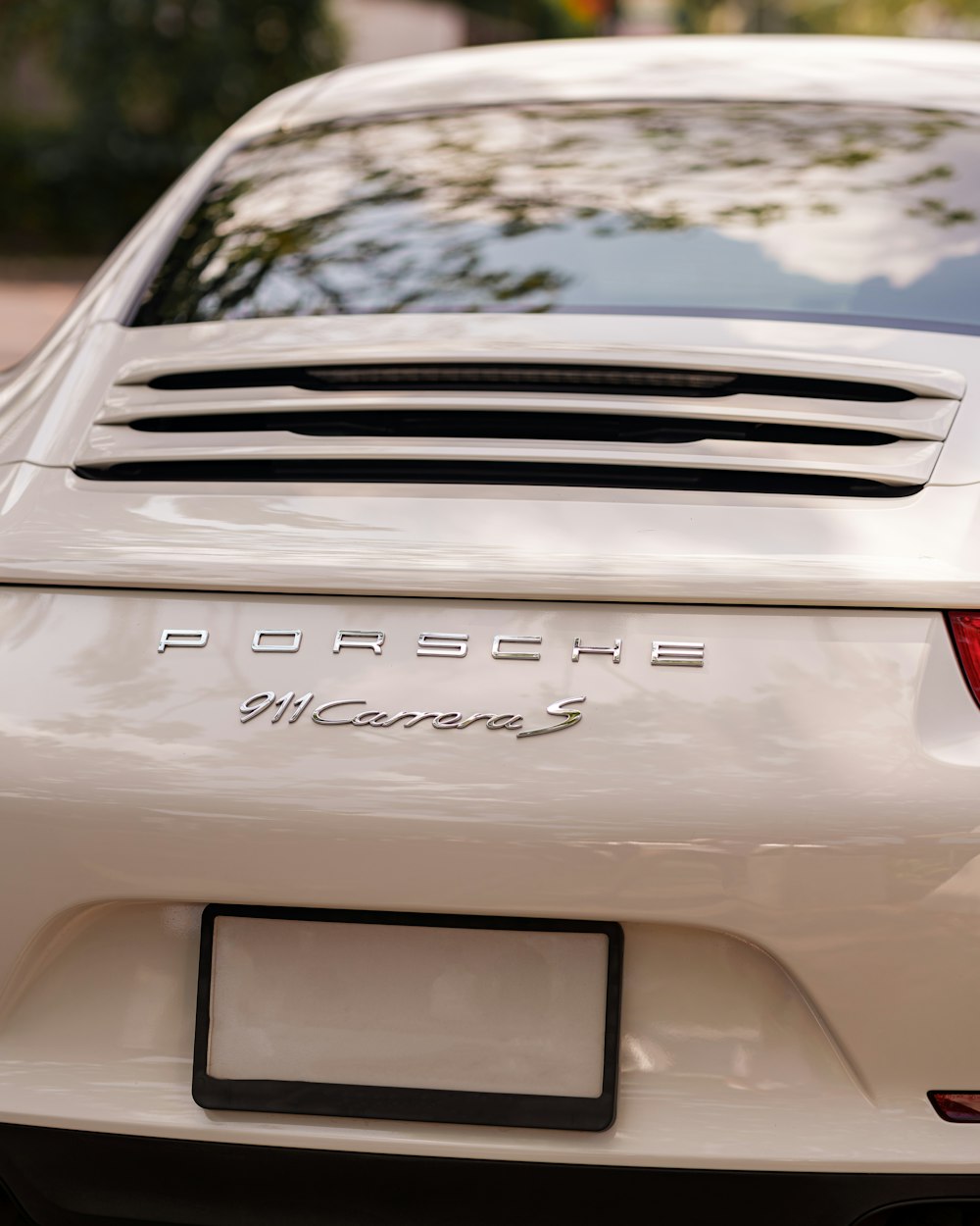 a white porsche parked on the side of the road