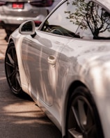 A clean vehicle reflecting sunlight in an outdoor setting.