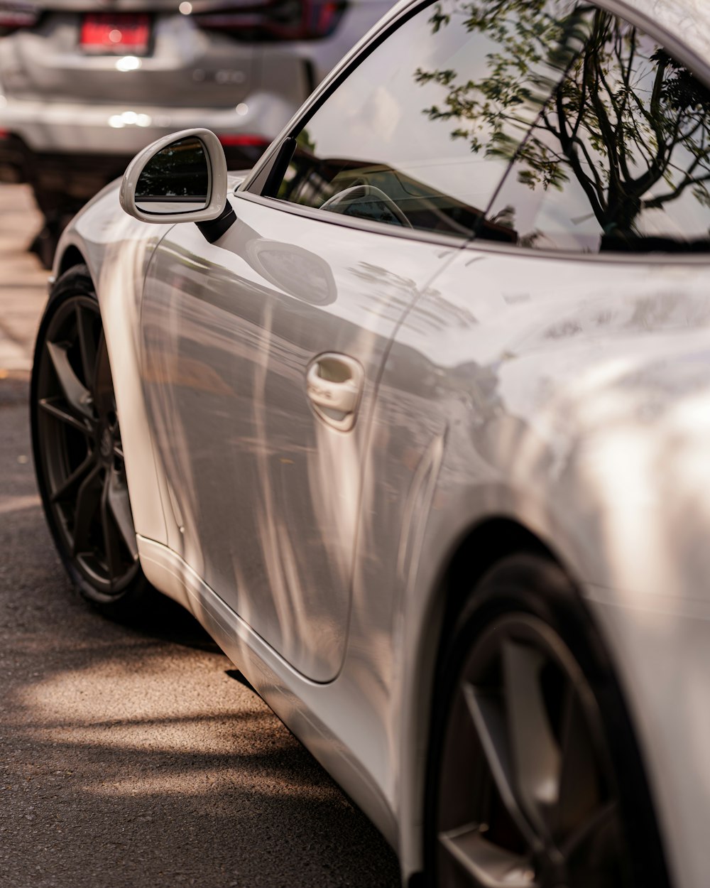 a white sports car parked on the side of the road