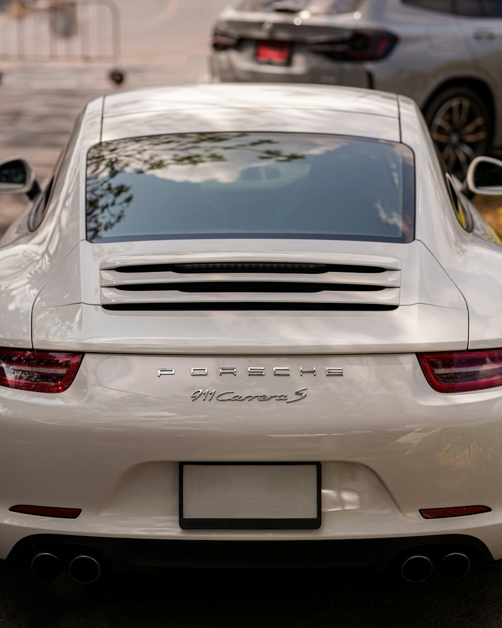 a white sports car parked on the side of the road