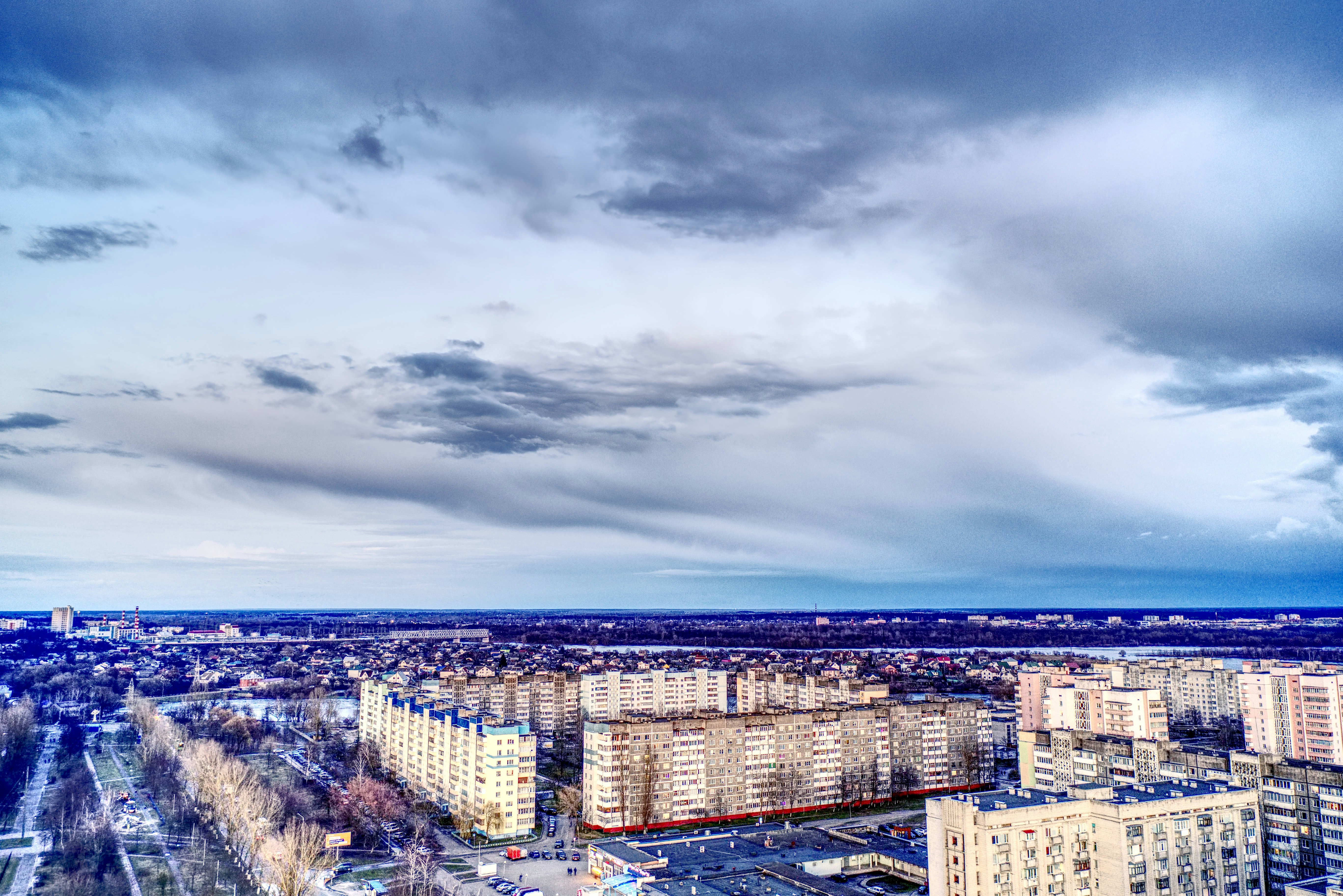 a view of a city with tall buildings under a cloudy sky