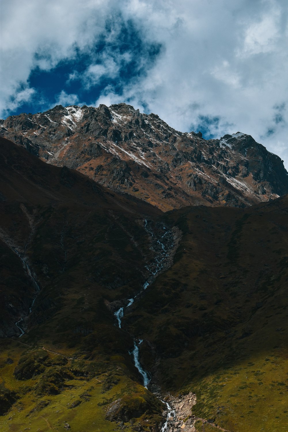 a mountain with a stream running through it