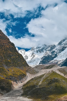 A picturesque landscape of mountains with a scoop of ice cream in the center.