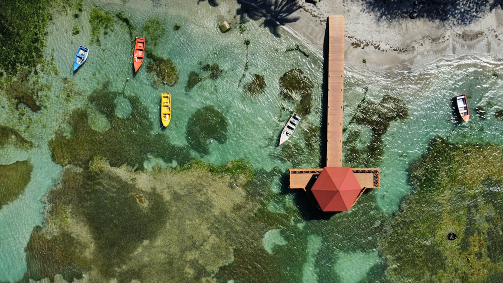 an aerial view of a pier with boats in the water