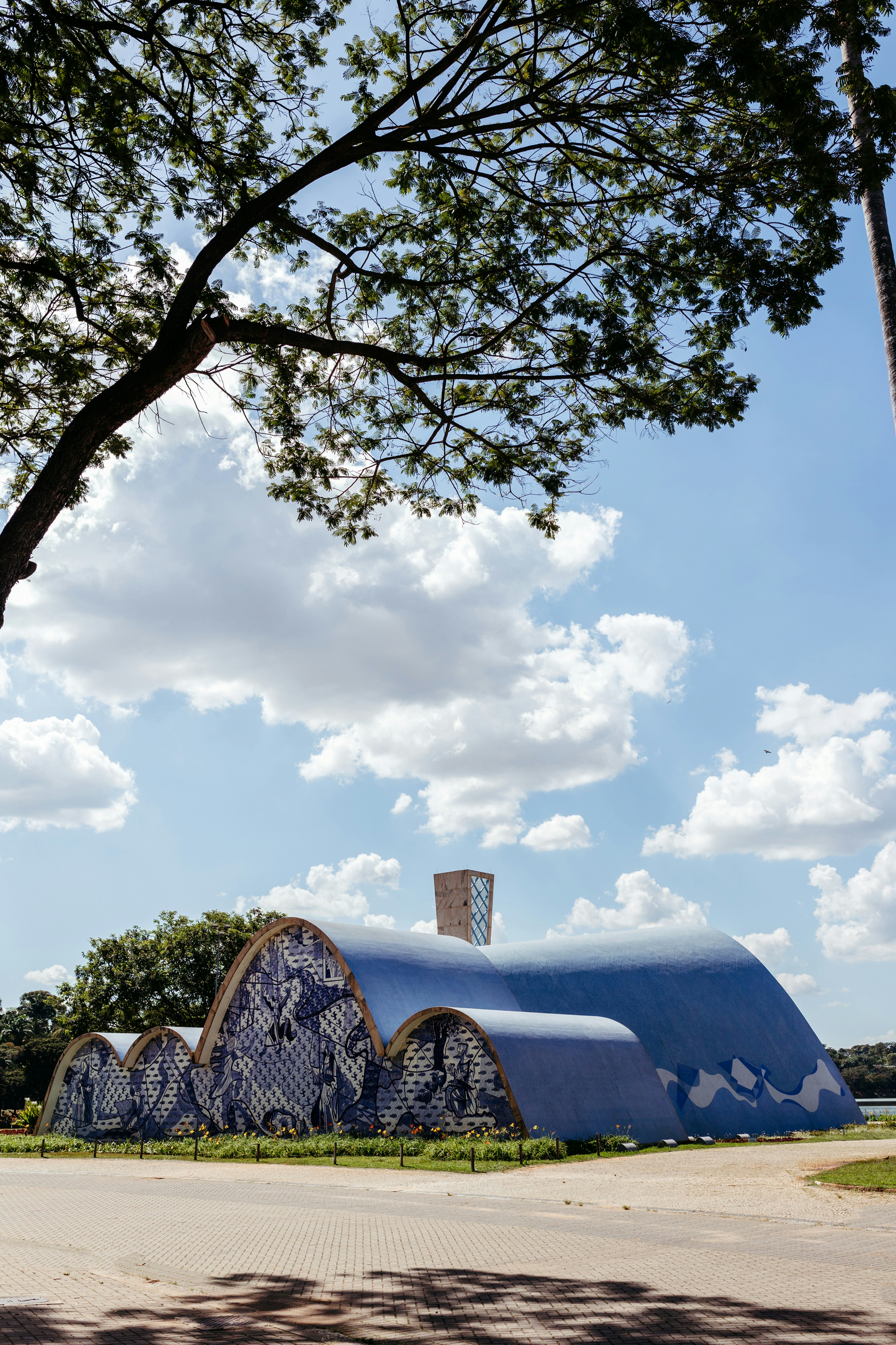 a large blue structure sitting under a tree