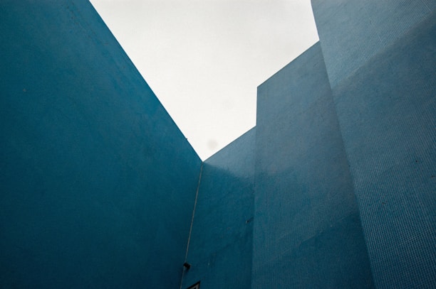 Modern architectural blueprint overlaying a dark blue textured background.