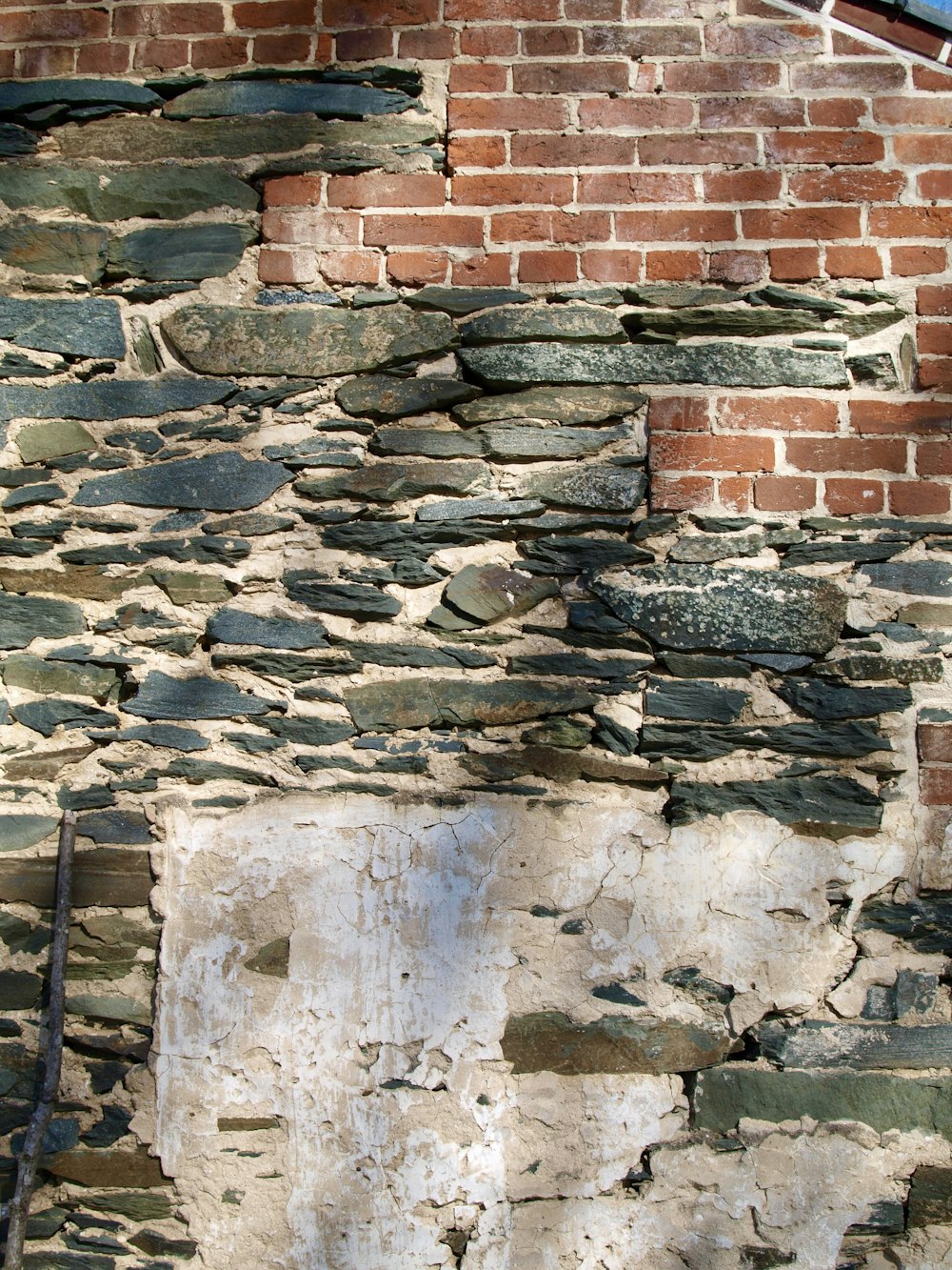 a brick wall with a clock on the side of it