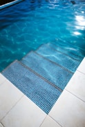 A beautifully maintained swimming pool with clear blue water.