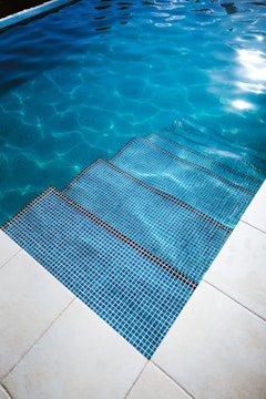 A beautifully maintained swimming pool with clear blue water.