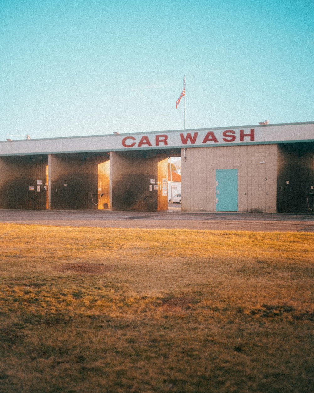 a car wash building with a flag on top of it