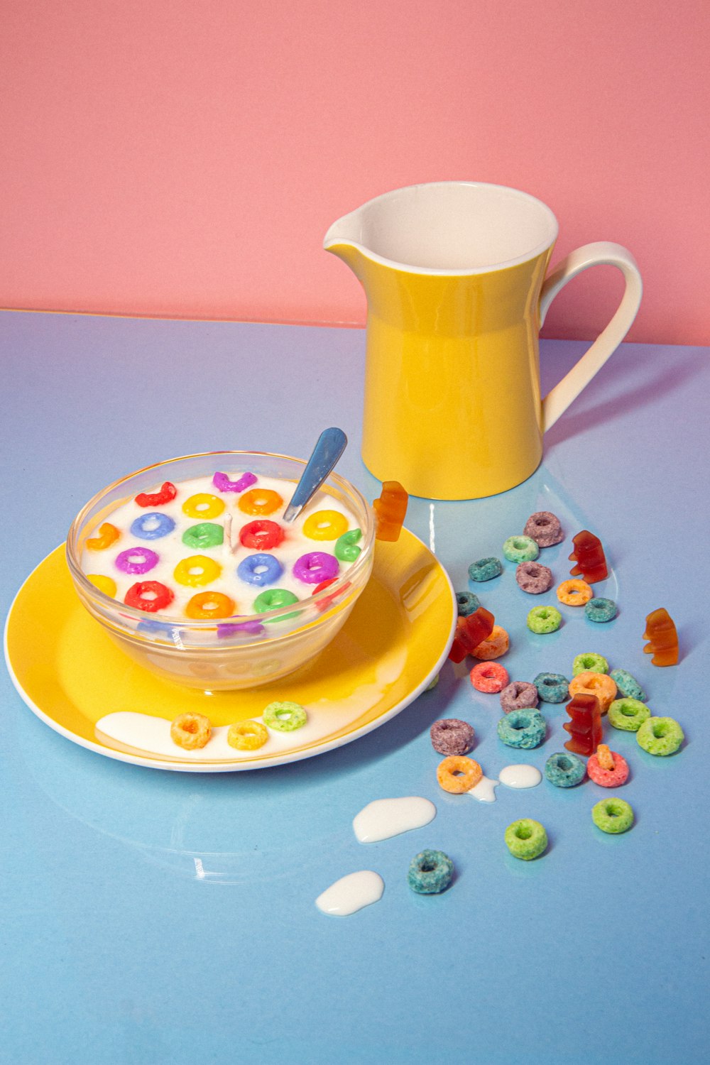 a bowl of cereal and a pitcher of cereal on a table