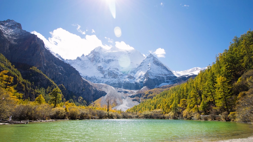 a mountain range with a lake in the foreground