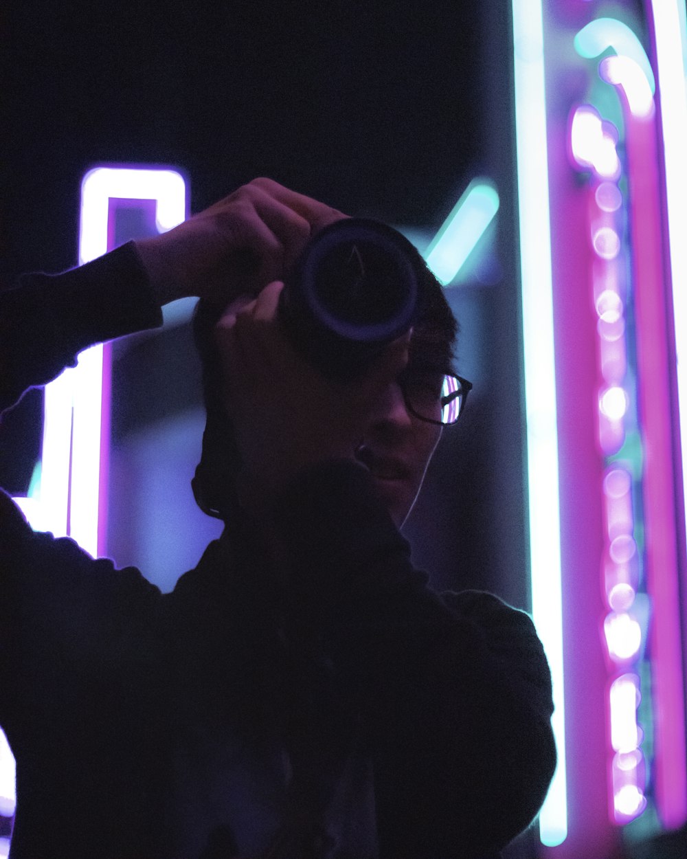 a man holding a camera up to his face