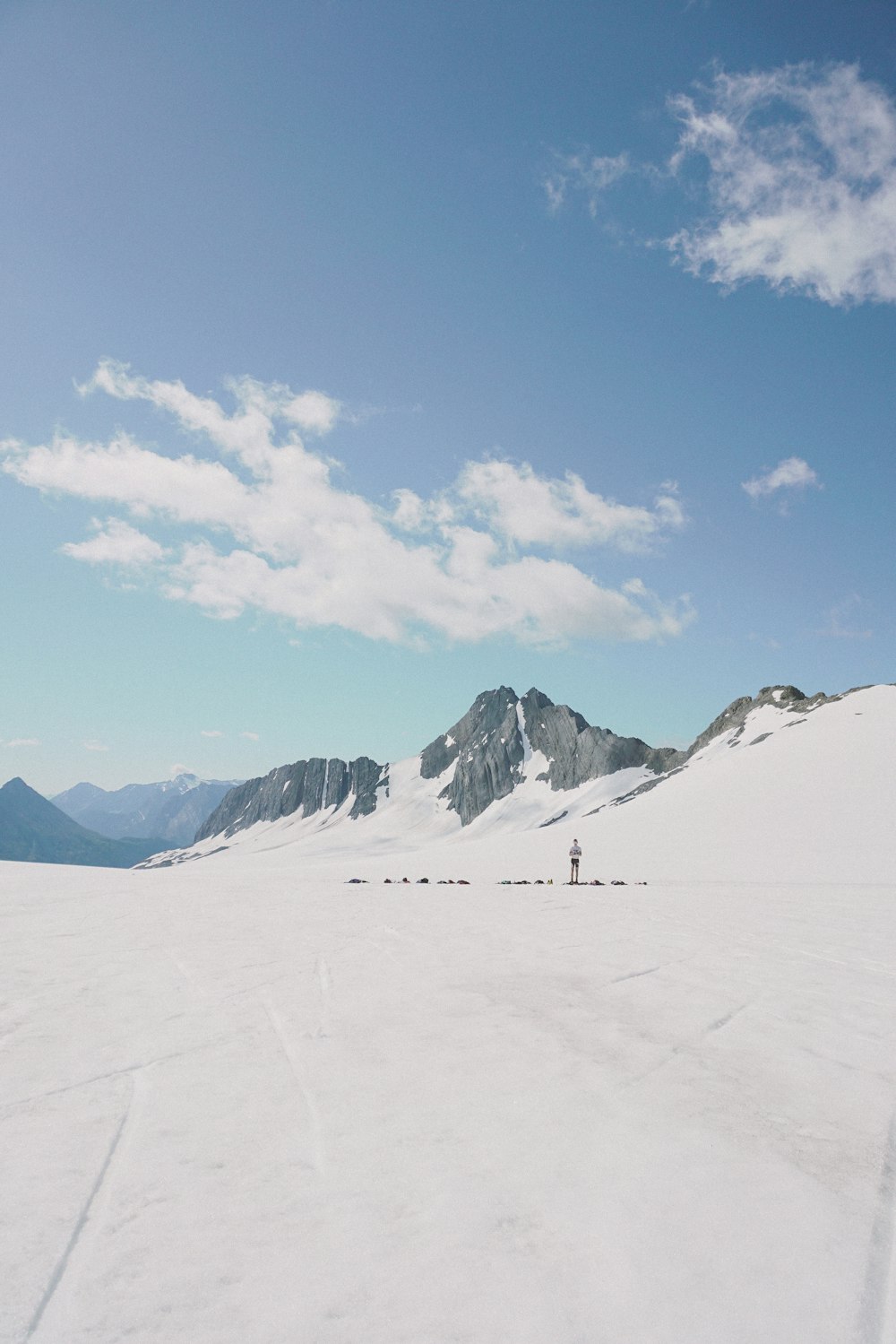 a person standing in the middle of a snow covered field