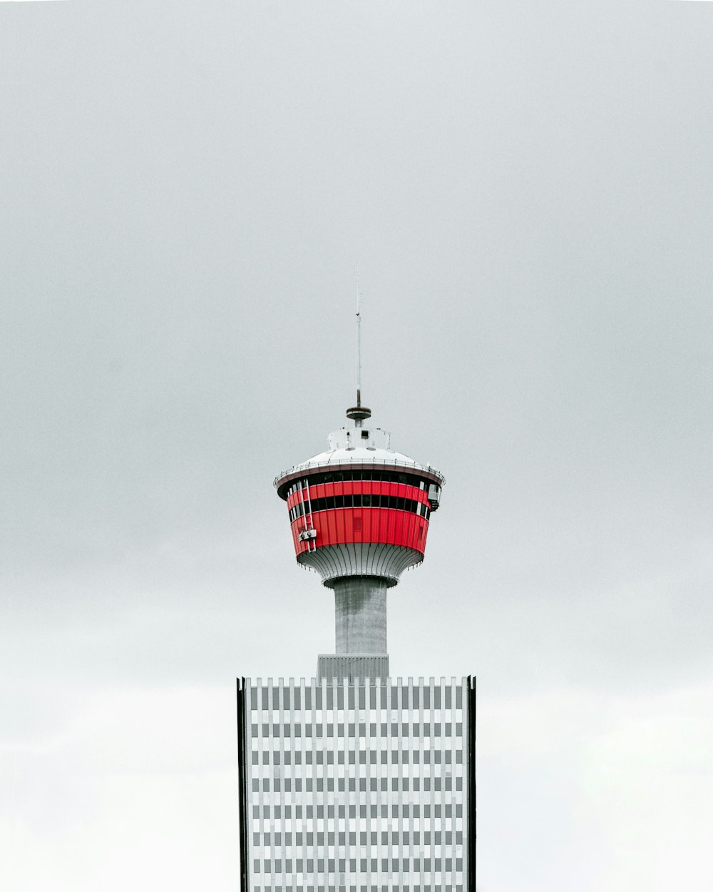 a red and white tower on top of a building