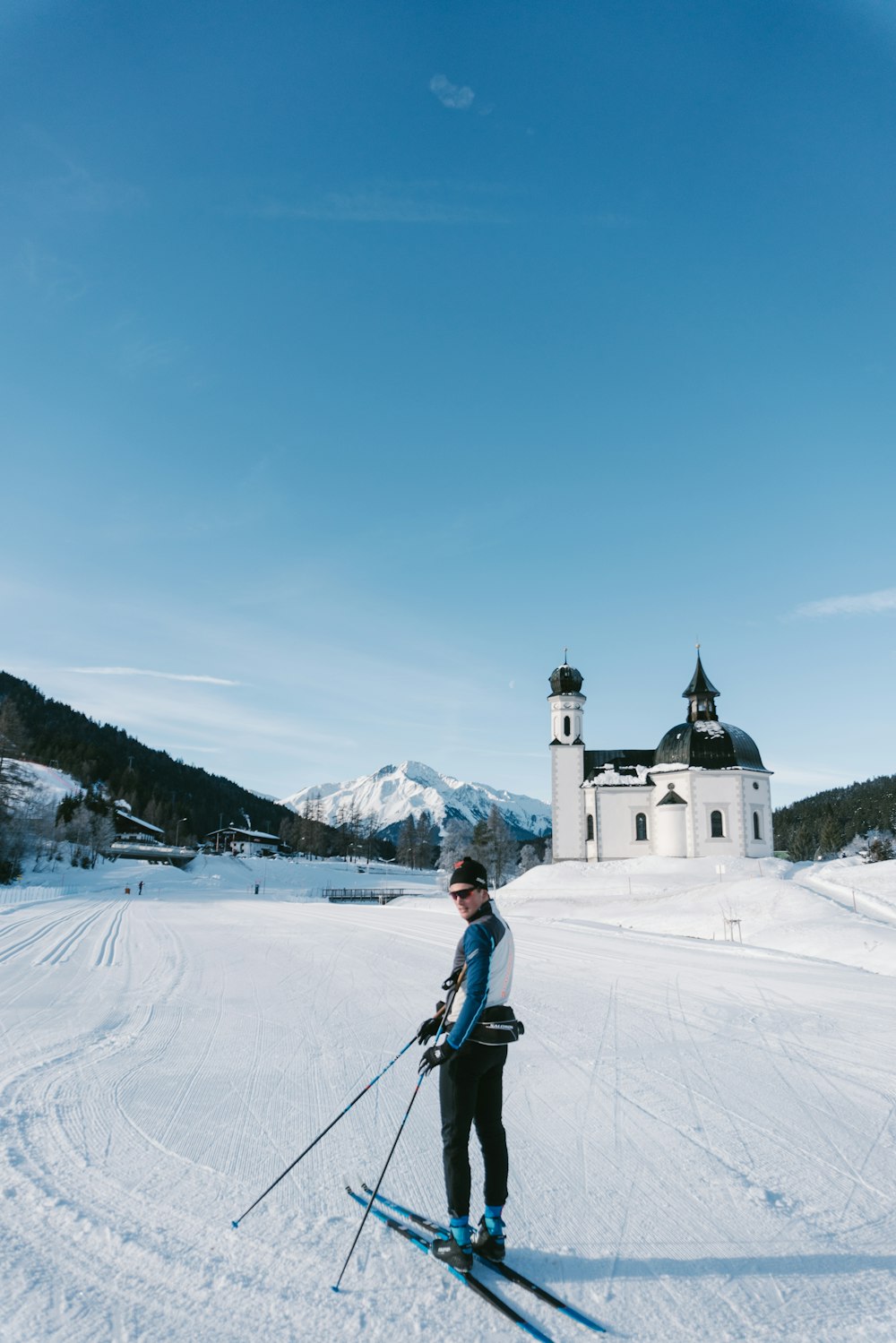 a person riding skis on a snowy surface