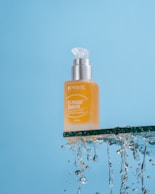 a bottle of prime oil sitting on top of a blue surface