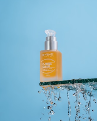 a bottle of prime oil sitting on top of a blue surface