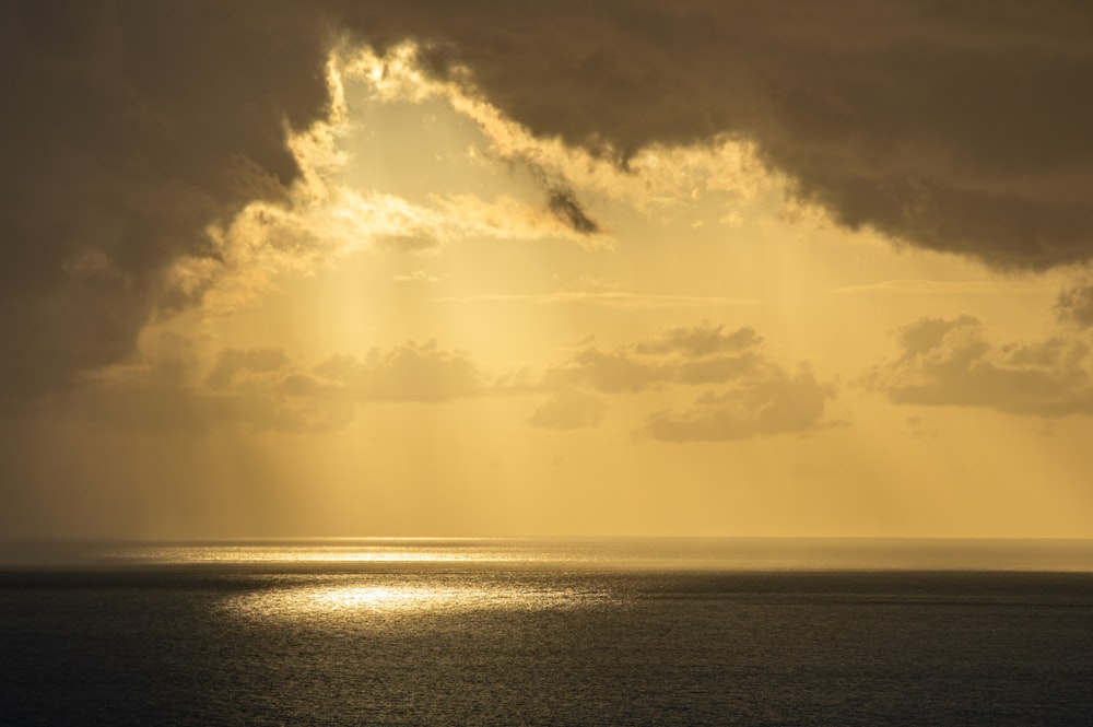 a large body of water under a cloudy sky