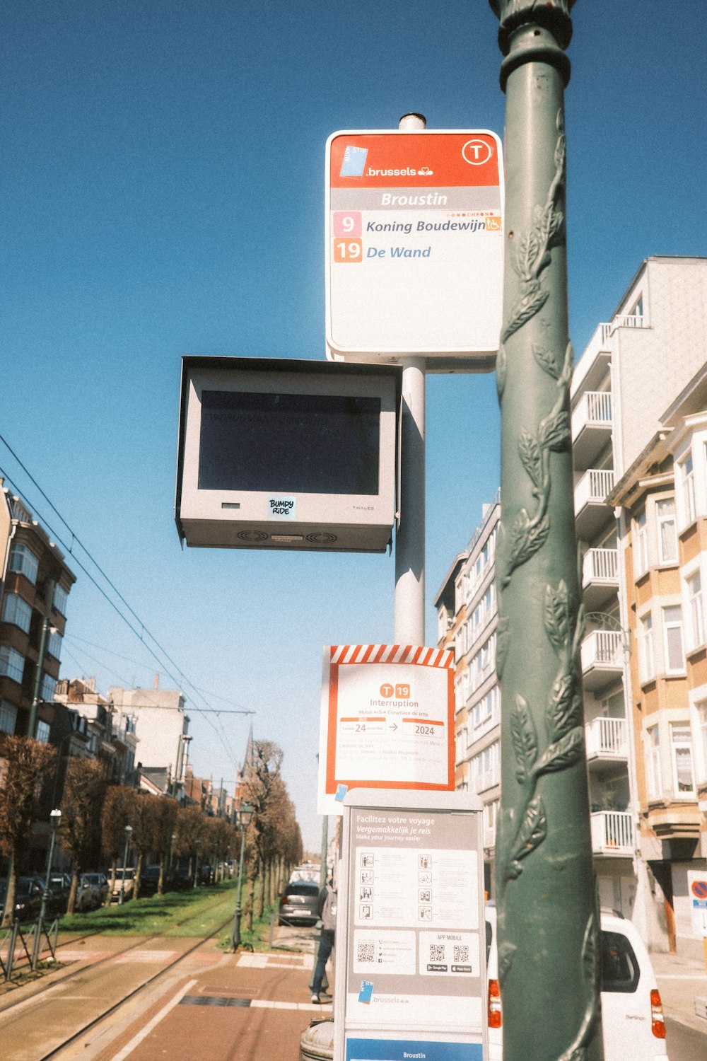 a street sign with a tv mounted to it's side