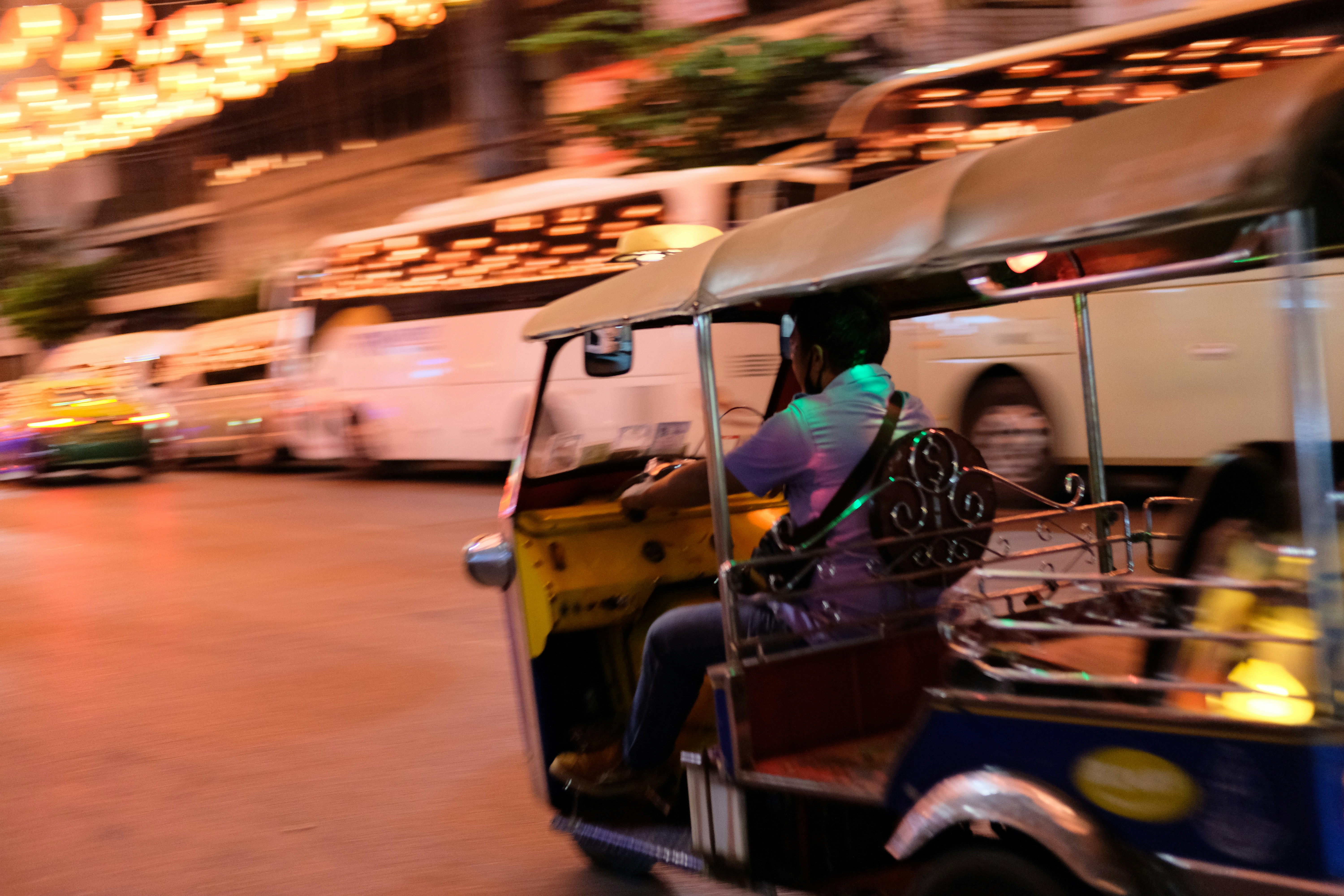 a man driving a cart down a street