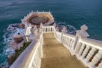 a staircase leading down to the ocean with a compass on it