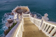 a staircase leading down to the ocean with a compass on it