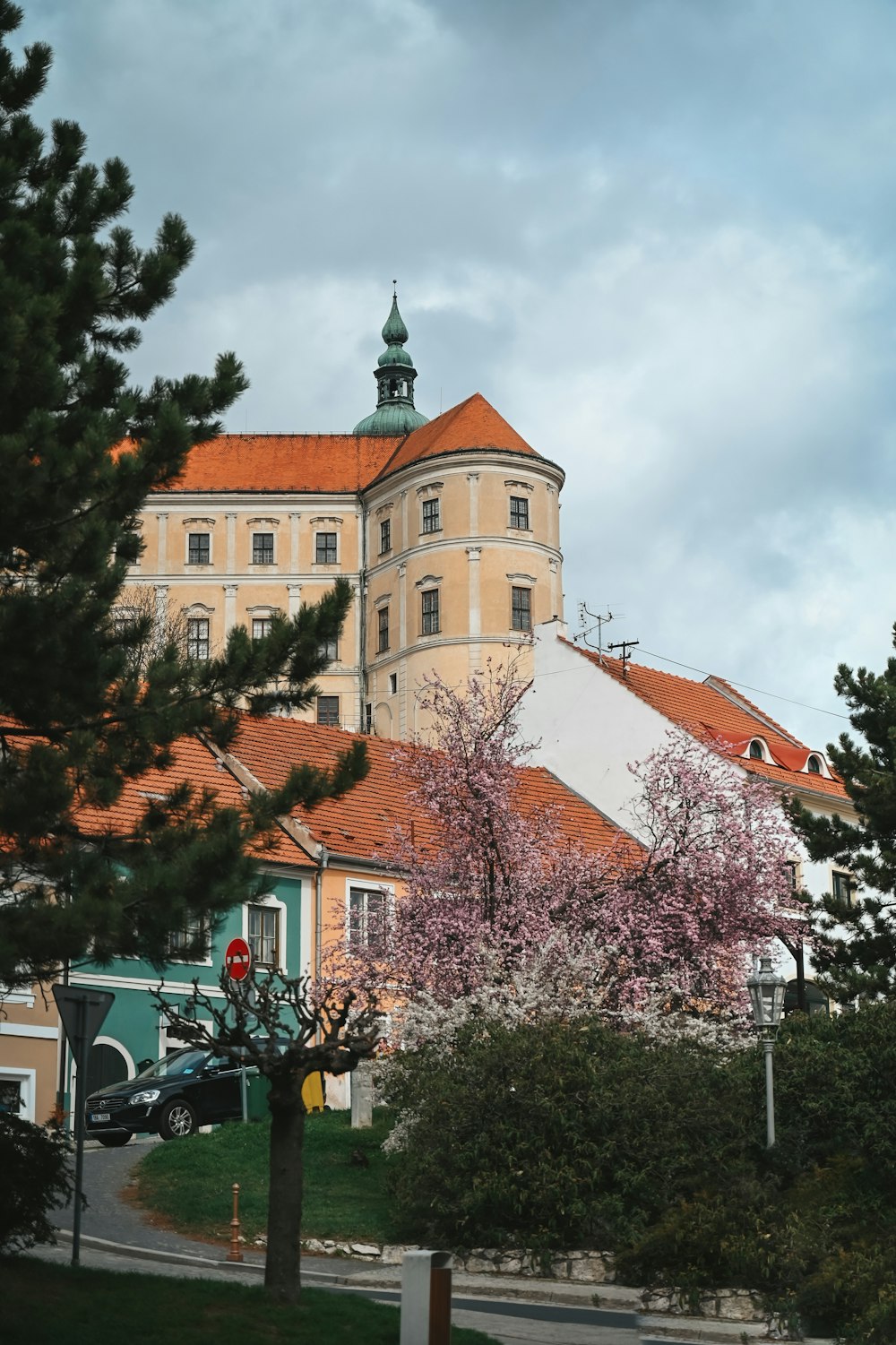 a large building with a red roof surrounded by trees