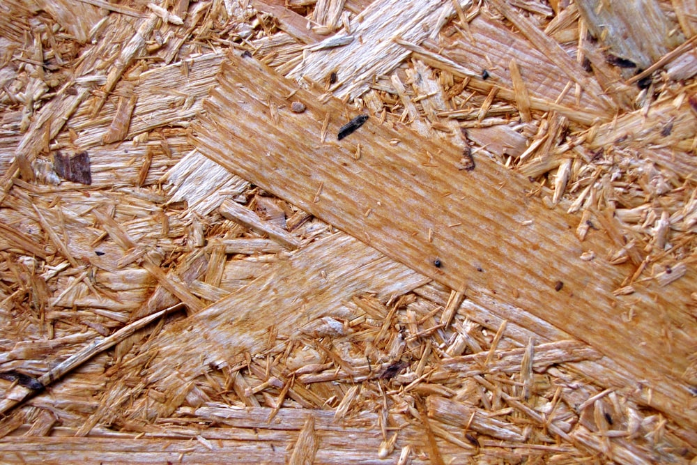 a close up of a wooden floor with wood shavings