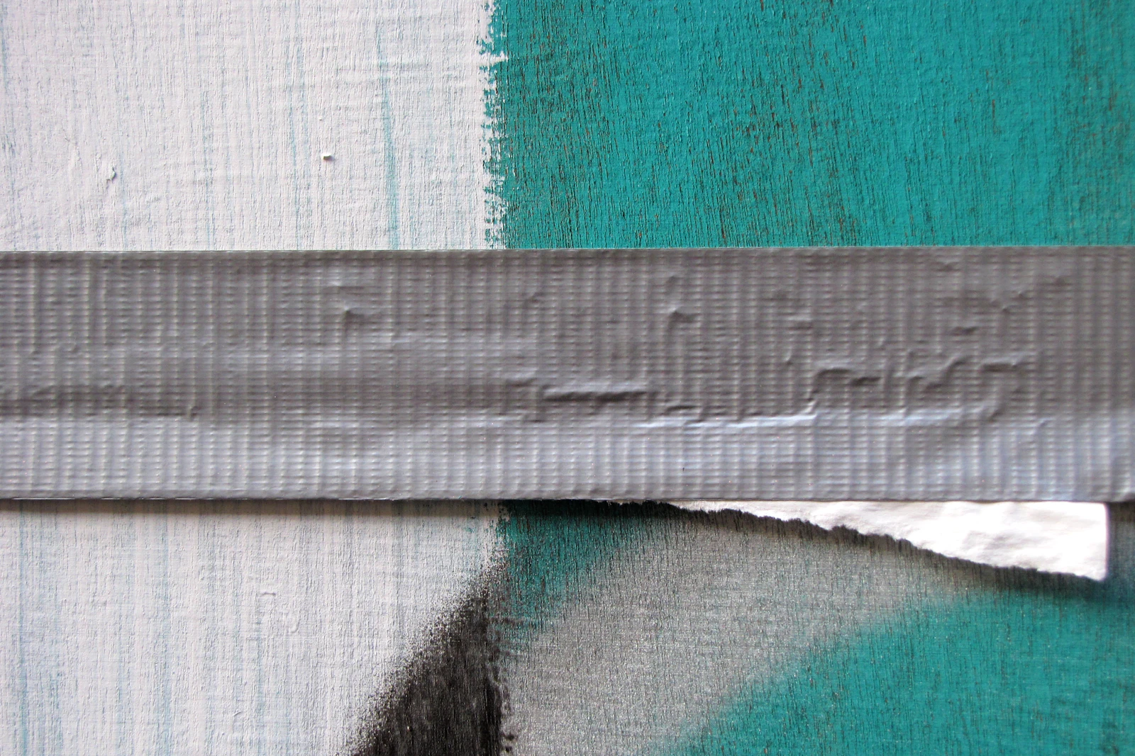 A strip of duct tape patched onto a surface, representing dynamic rendering as a stopgap workaround rather than a long-term rendering architecture