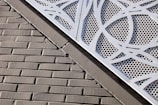 Decorative perforated metal wall panel in a stylish office setting.