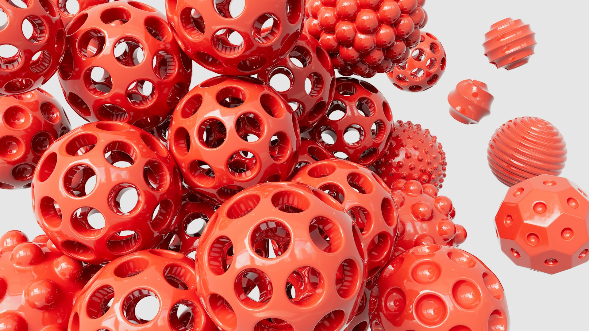 a pile of red plastic balls with holes on them