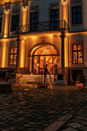 Hotel exterior with warm lighting and classic Andalusian architecture